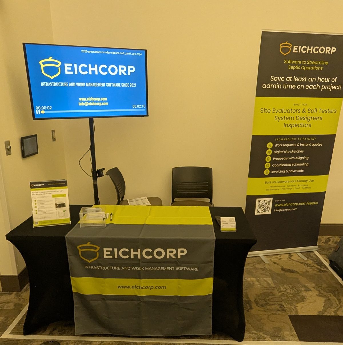 The Eichcorp booth at the 2026 Tools and Technology Expo, with a table, video display, and a banner reading Software to Streamline Septic Operations